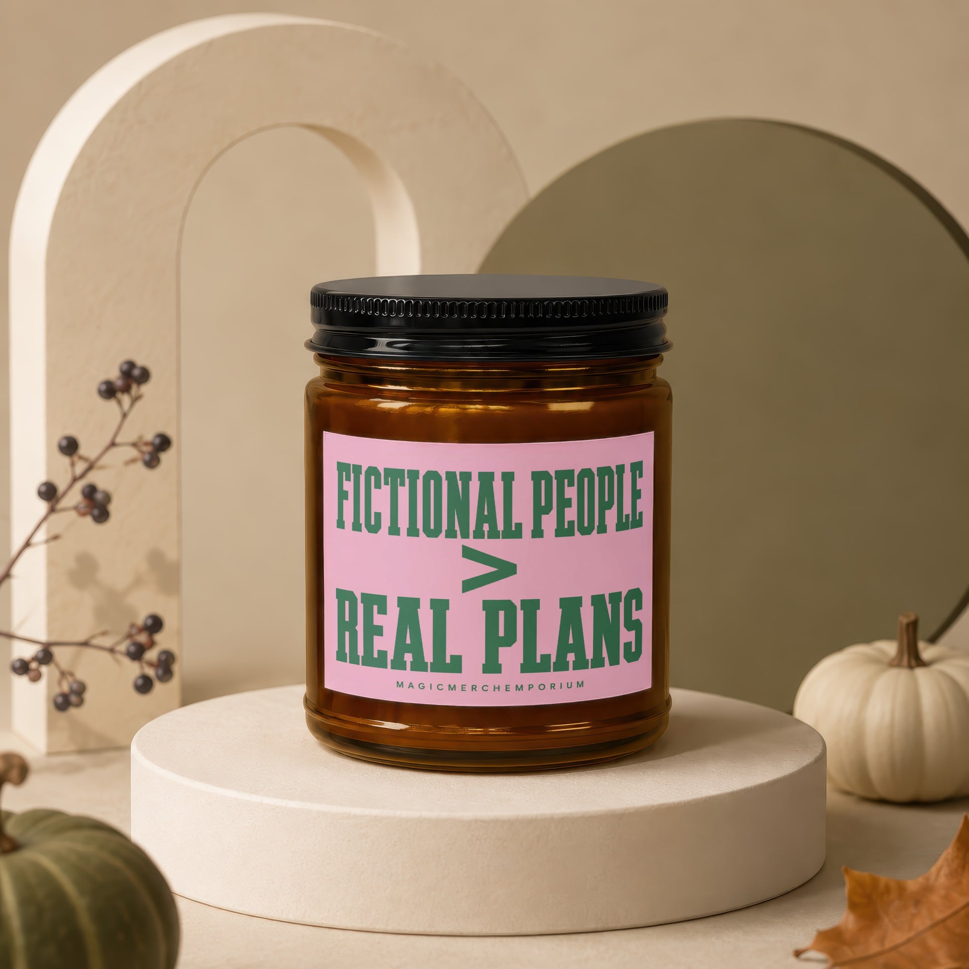 Amber jar candle with pink label reading "FICTIONAL PEOPLE > REAL PLANS"