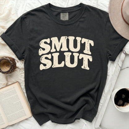 Black t-shirt with "SMUT SLUT" text in distressed cream-colored block letters.