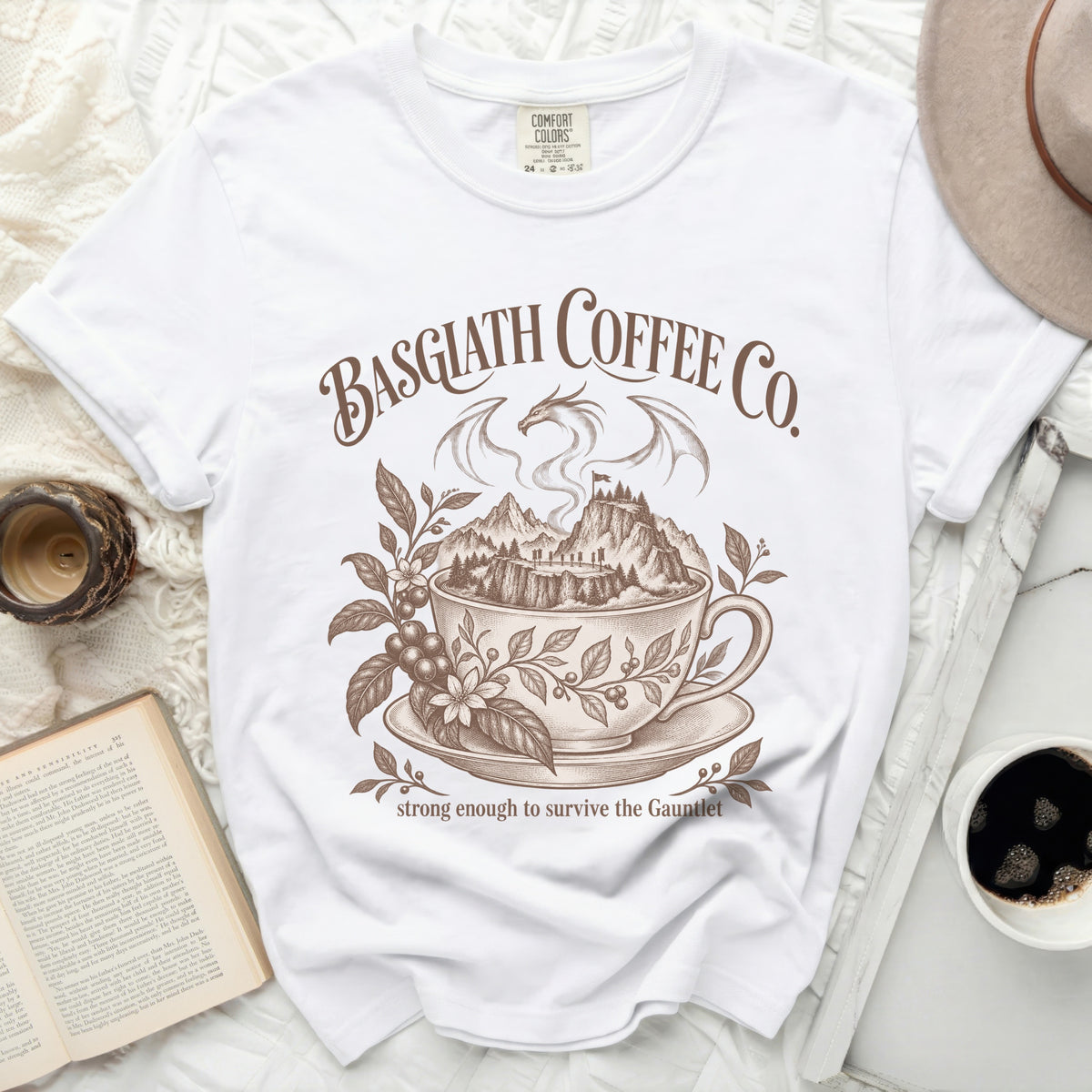 White t-shirt with Basgiath Coffee Co. dragon, mountains, and coffee cup design.