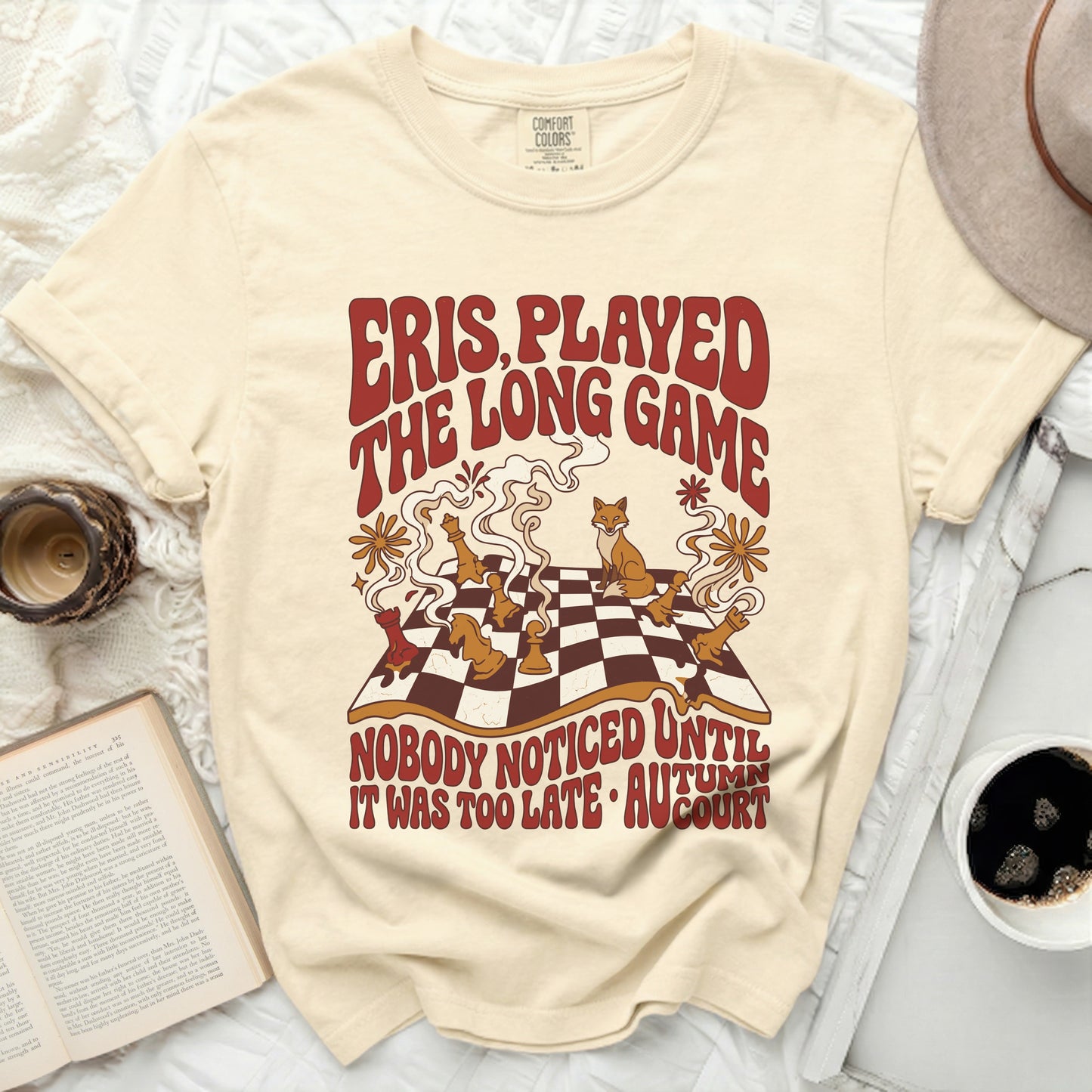 Cream t-shirt with "Eris Played The Long Game" text and fox chess illustration.