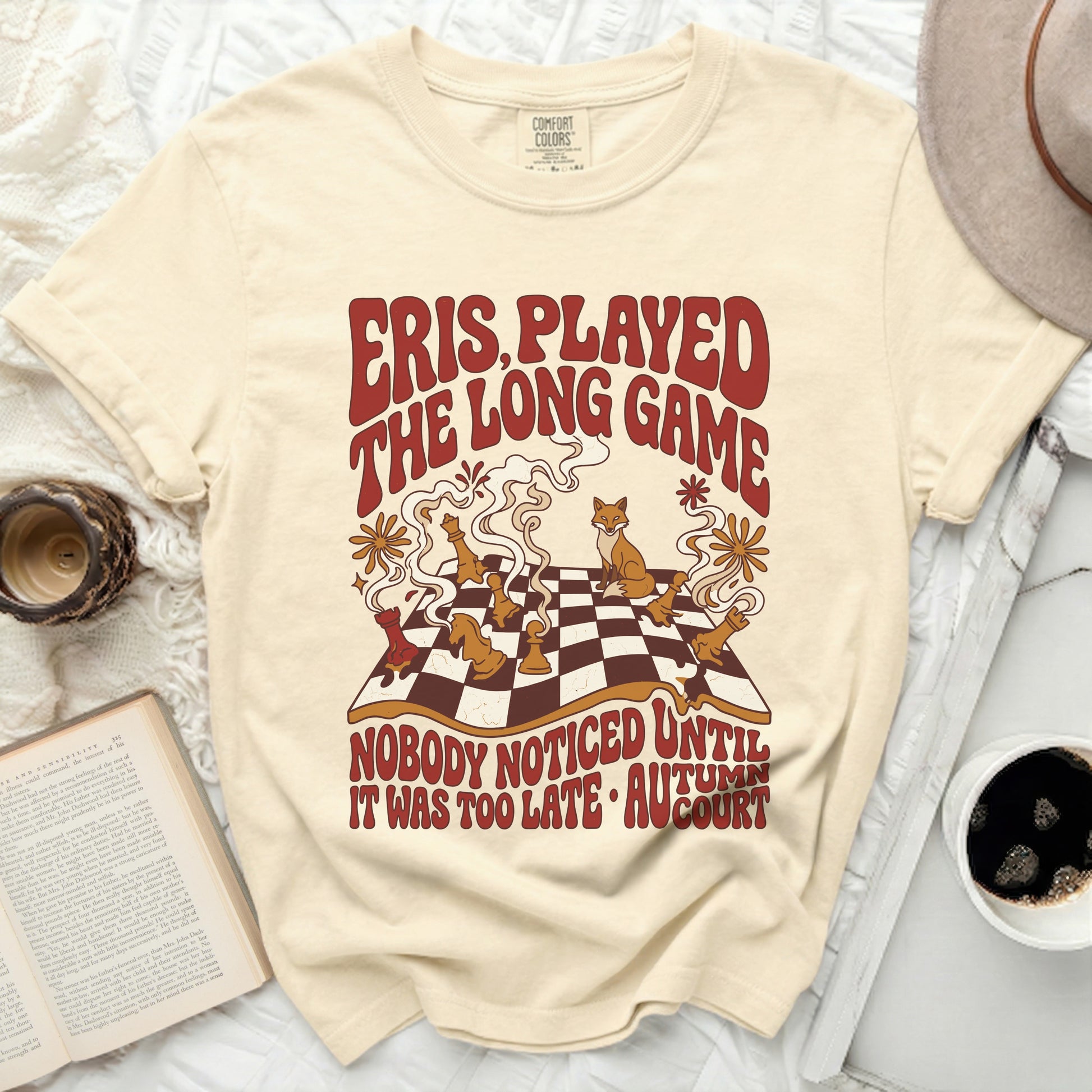 Cream t-shirt with "Eris Played The Long Game" text and fox chess illustration.