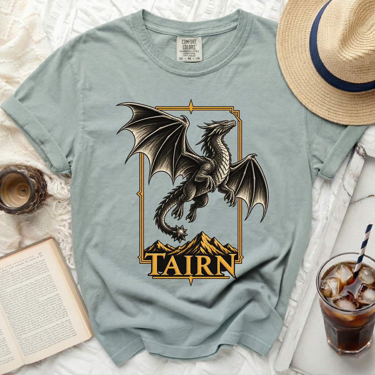 T-shirt with a black dragon graphic over mountains and the text "TAIRN".