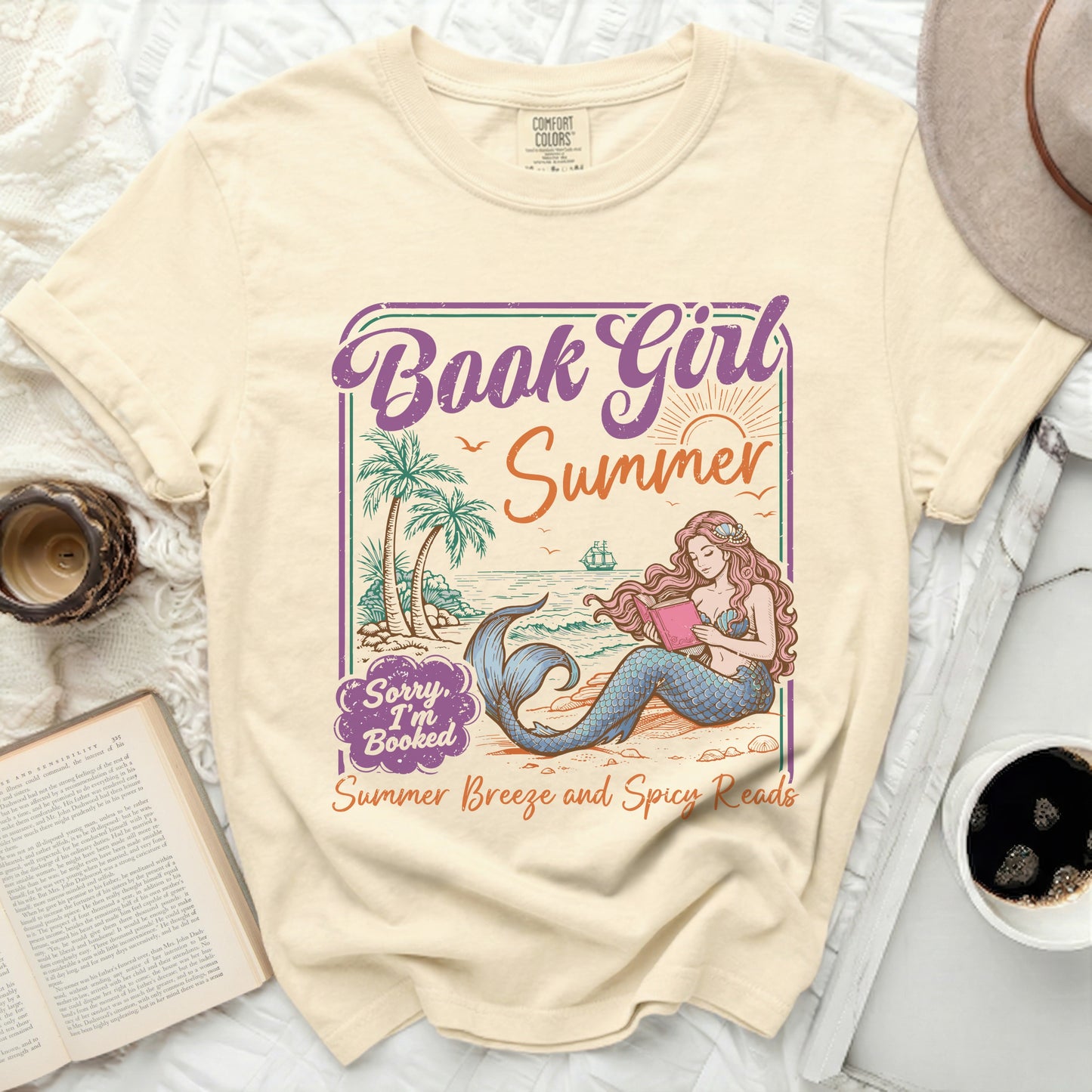 T-shirt with illustration of mermaid reading by the sea, "Book Girl Summer," and "Summer Breeze and Spicy Reads."