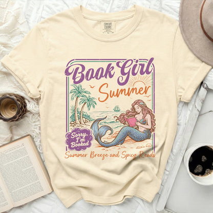 T-shirt with illustration of mermaid reading by the sea, "Book Girl Summer," and "Summer Breeze and Spicy Reads."
