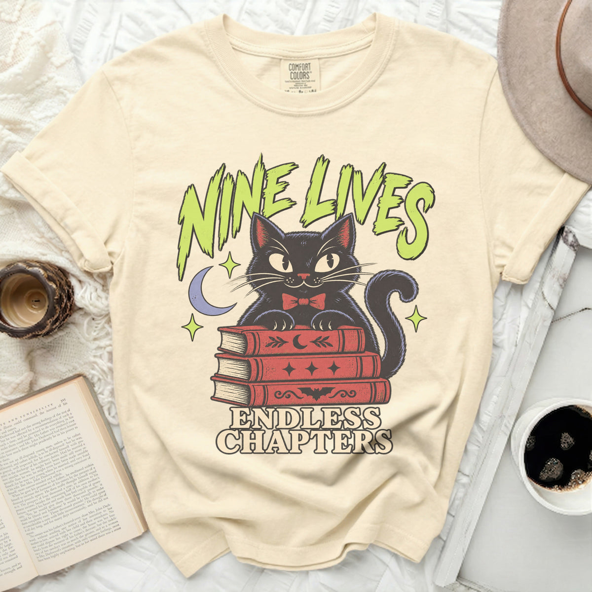 Black cat on stack of books with "NINE LIVES ENDLESS CHAPTERS" text.