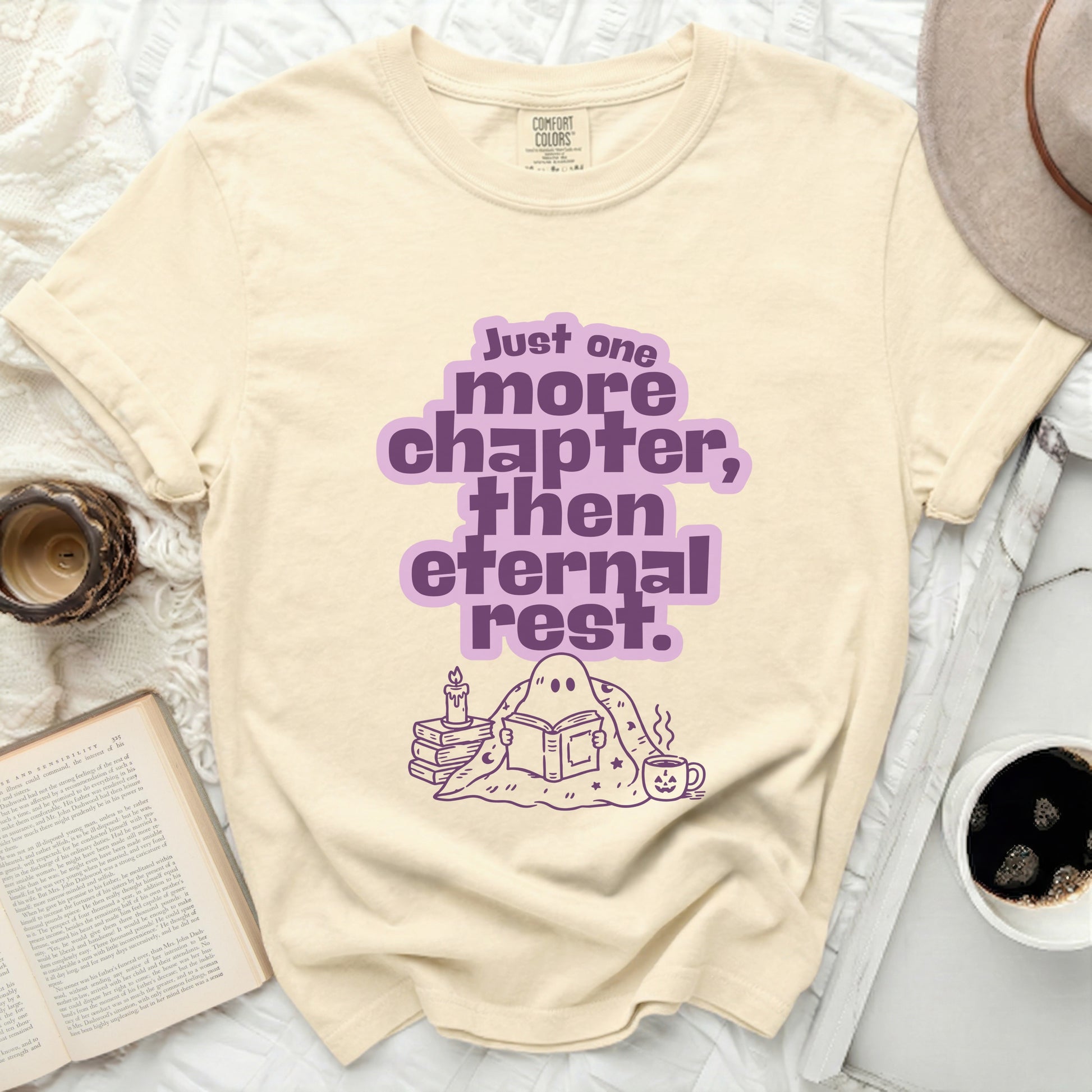 Cream t-shirt with "Just one more chapter, then eternal rest" text and a reading ghost.