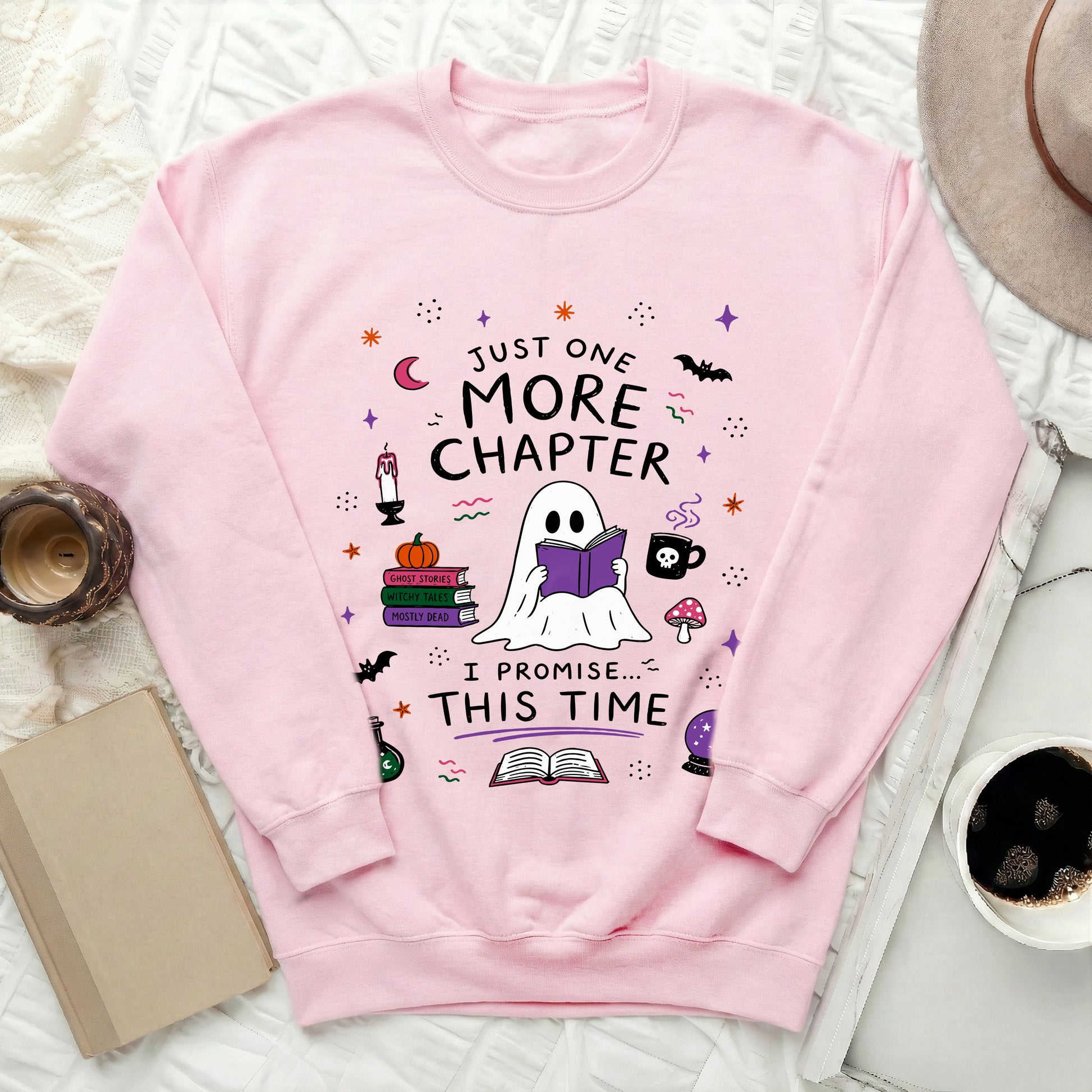 Pink sweatshirt with ghost reading "Just One More Chapter, I Promise... This Time".