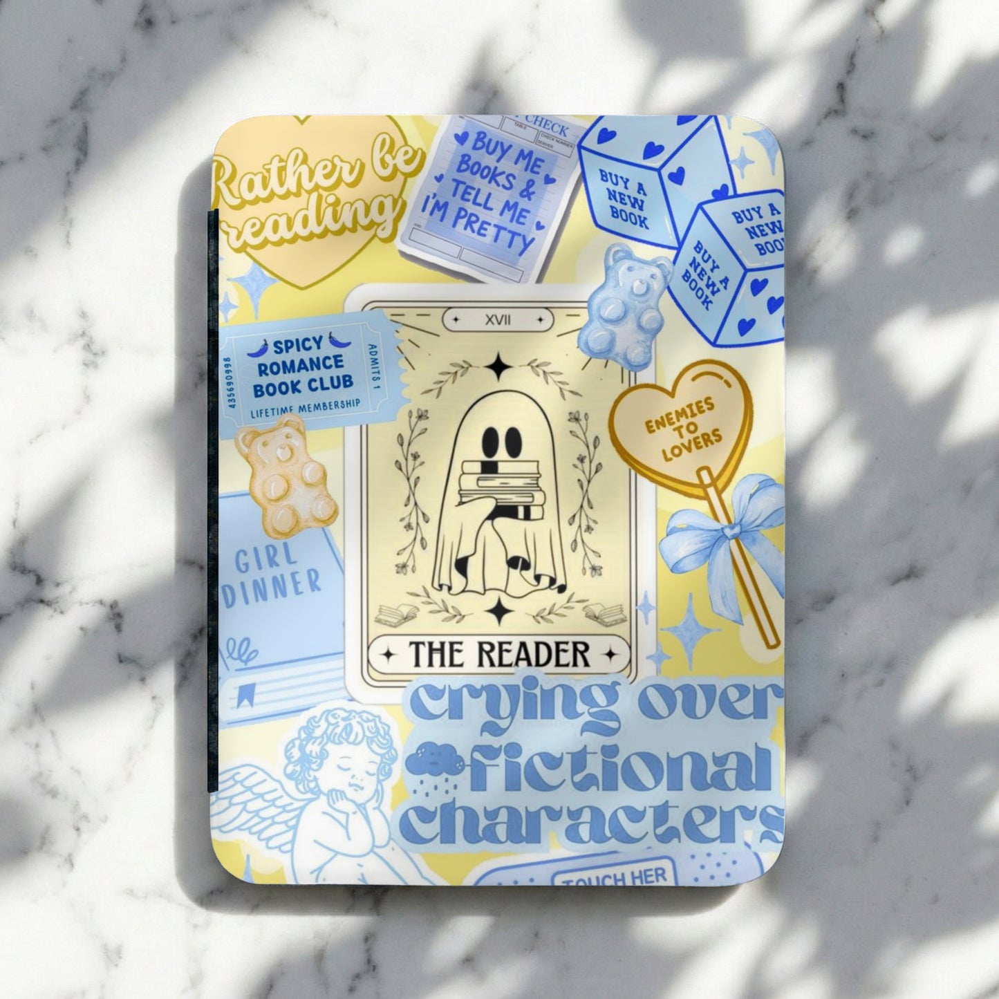 A notebook with a ghost holding books, text about reading, and gummy bears.