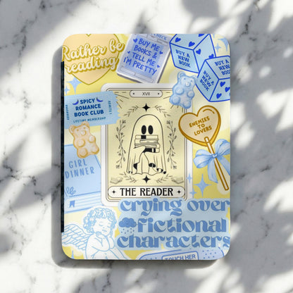 A notebook with a ghost holding books, text about reading, and gummy bears.