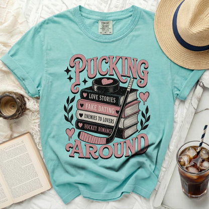 Mint t-shirt with "Pucking Around" hockey romance book design.