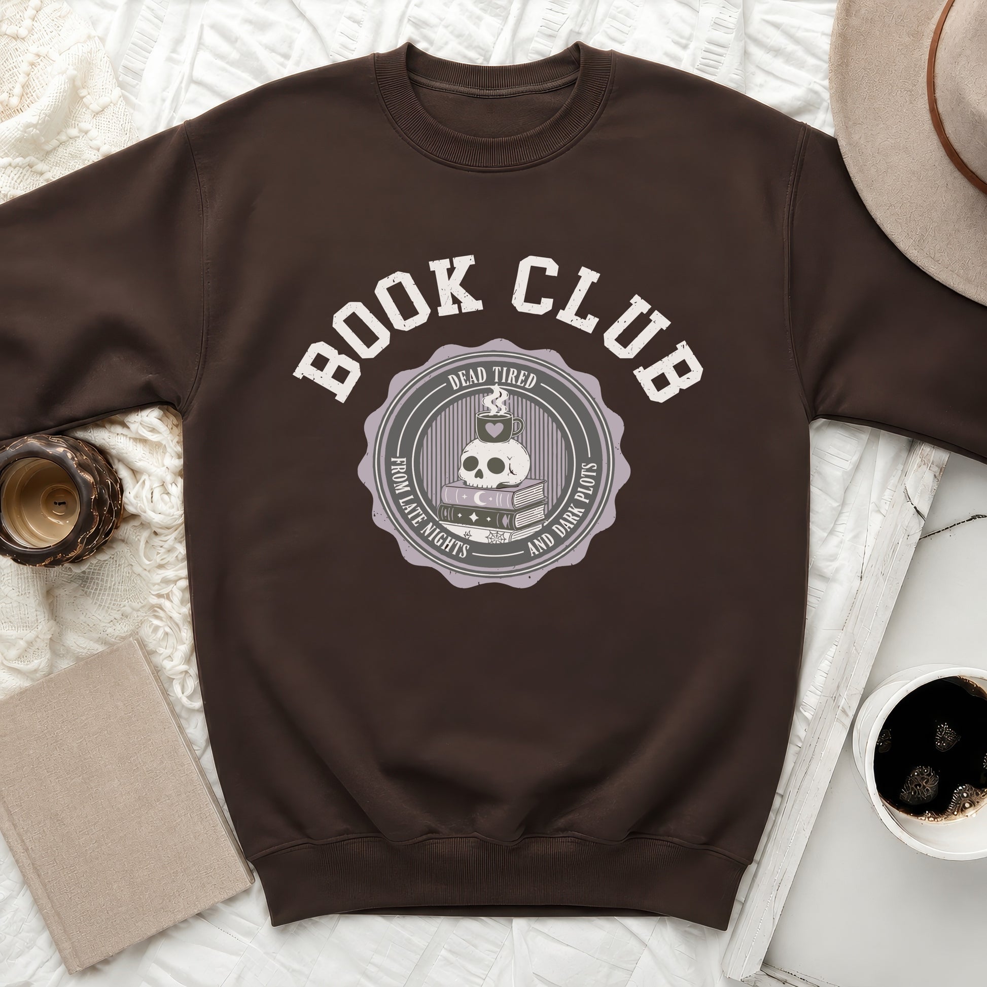 Brown sweatshirt with "Book Club" text and skull with coffee, books, and moon graphic.