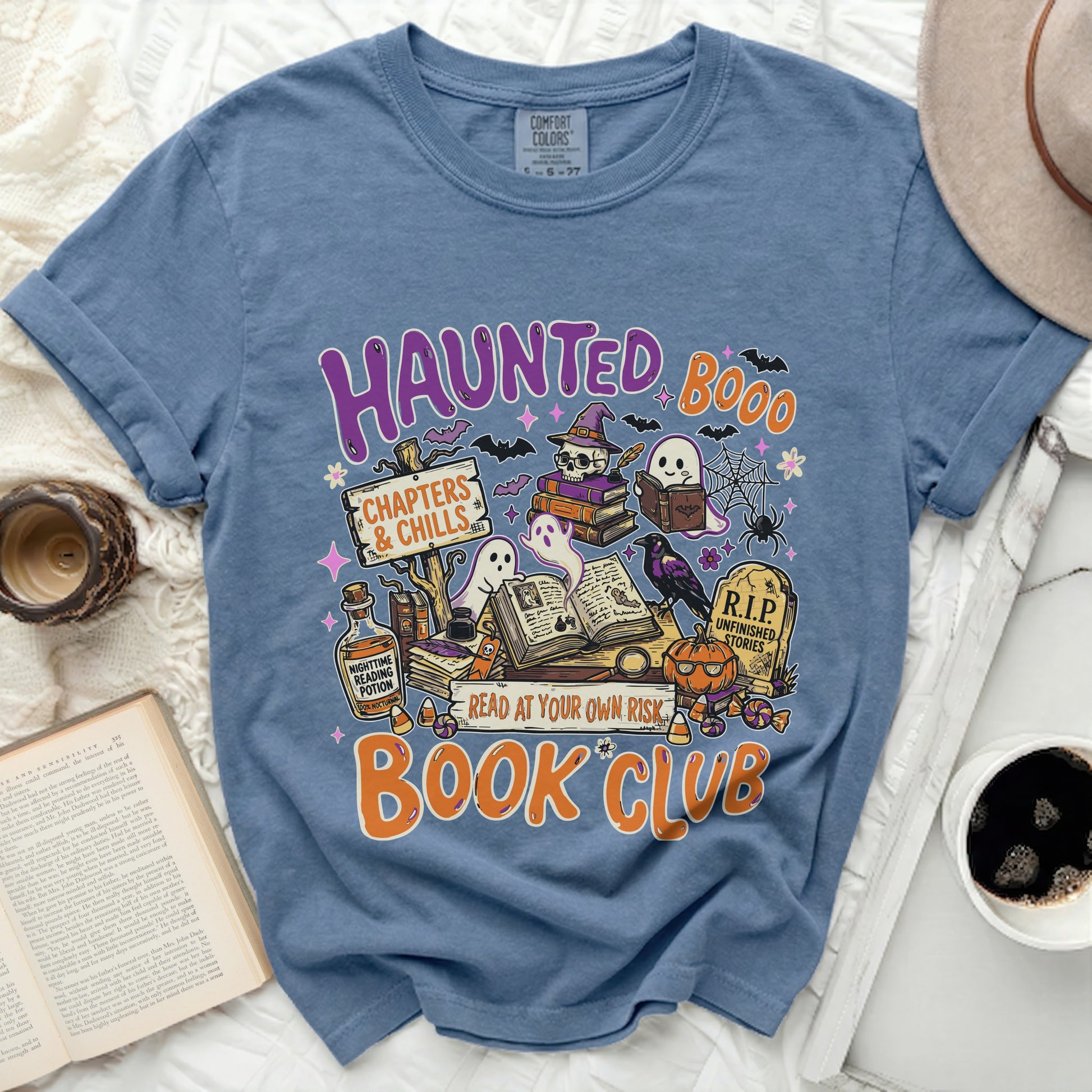 Blue t-shirt with "Haunted Book Club" graphic featuring ghosts, bats, and books.