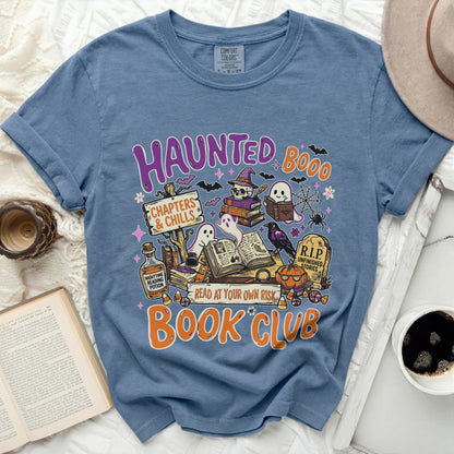 Blue t-shirt with "Haunted Book Club" graphic featuring ghosts, bats, and books.