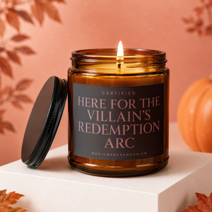 Amber candle with lid nearby, lit flame, and text "Here for the Villain's Redemption Arc".