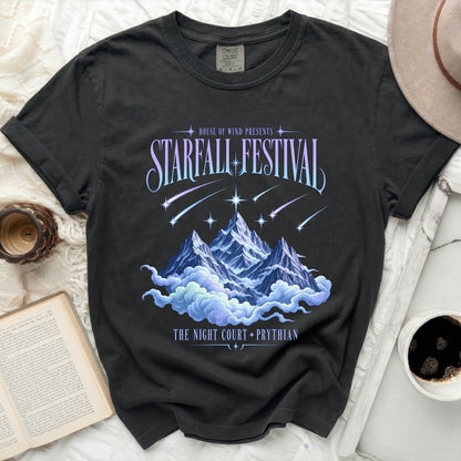 Black t-shirt with "Starfall Festival" design, mountains, clouds, and text.