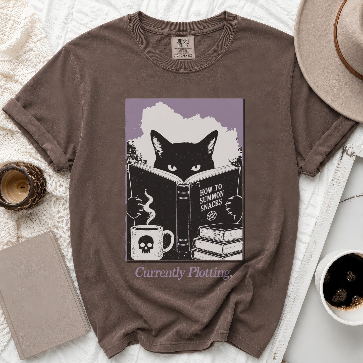 Brown t-shirt with black cat reading "How to Summon Snacks," holding skull mug.