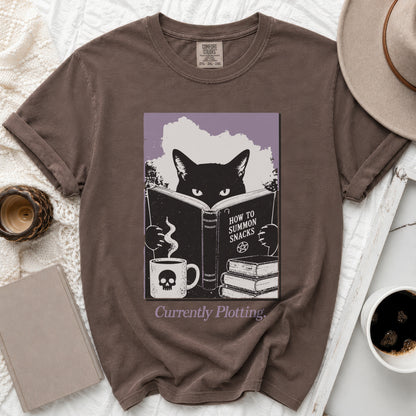 Brown t-shirt with black cat reading "How to Summon Snacks," holding skull mug.