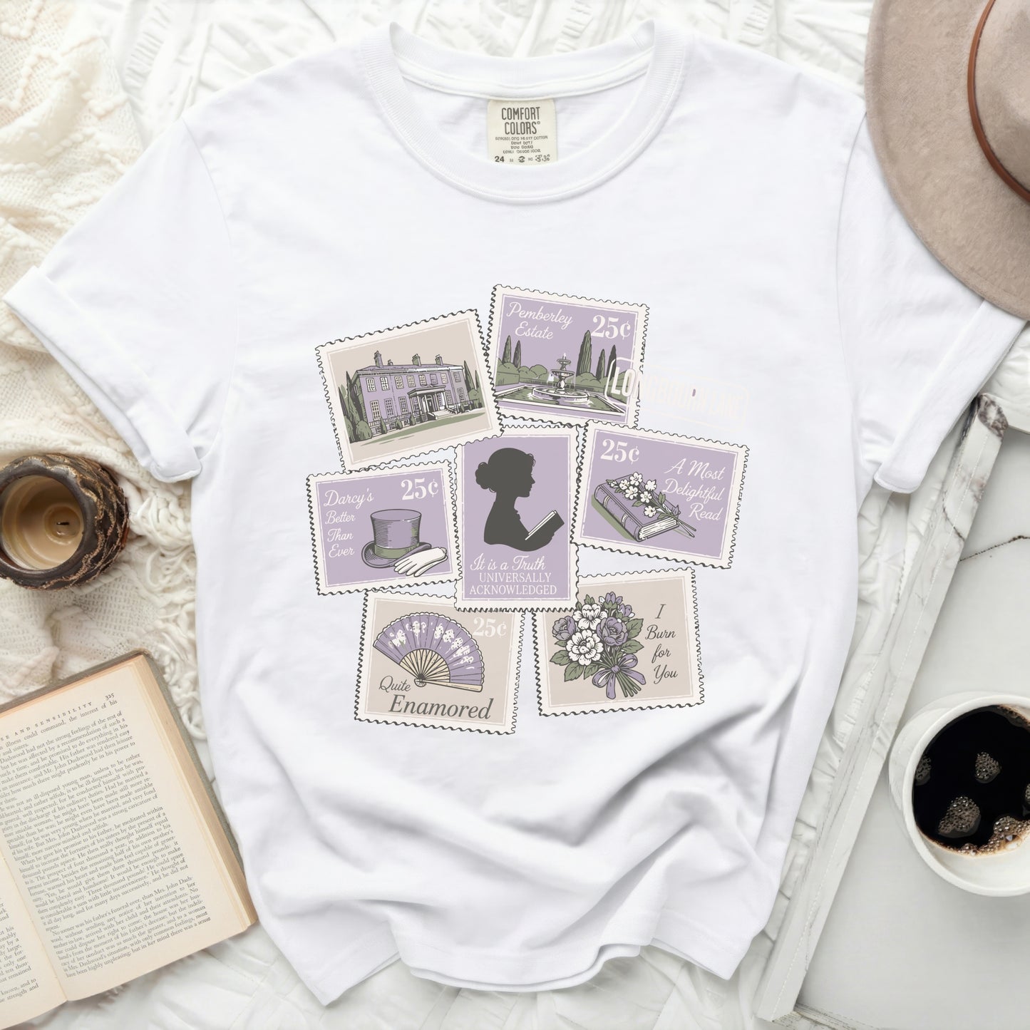 White t-shirt with postage stamp-style graphics of Pemberley, books, and phrases.