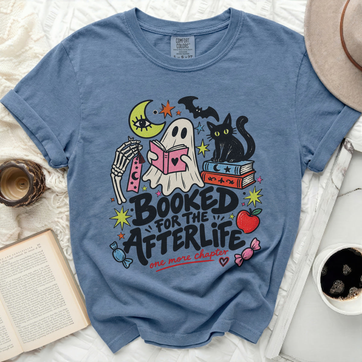 T-shirt with ghost, black cat, moon, and text "Booked for the Afterlife".
