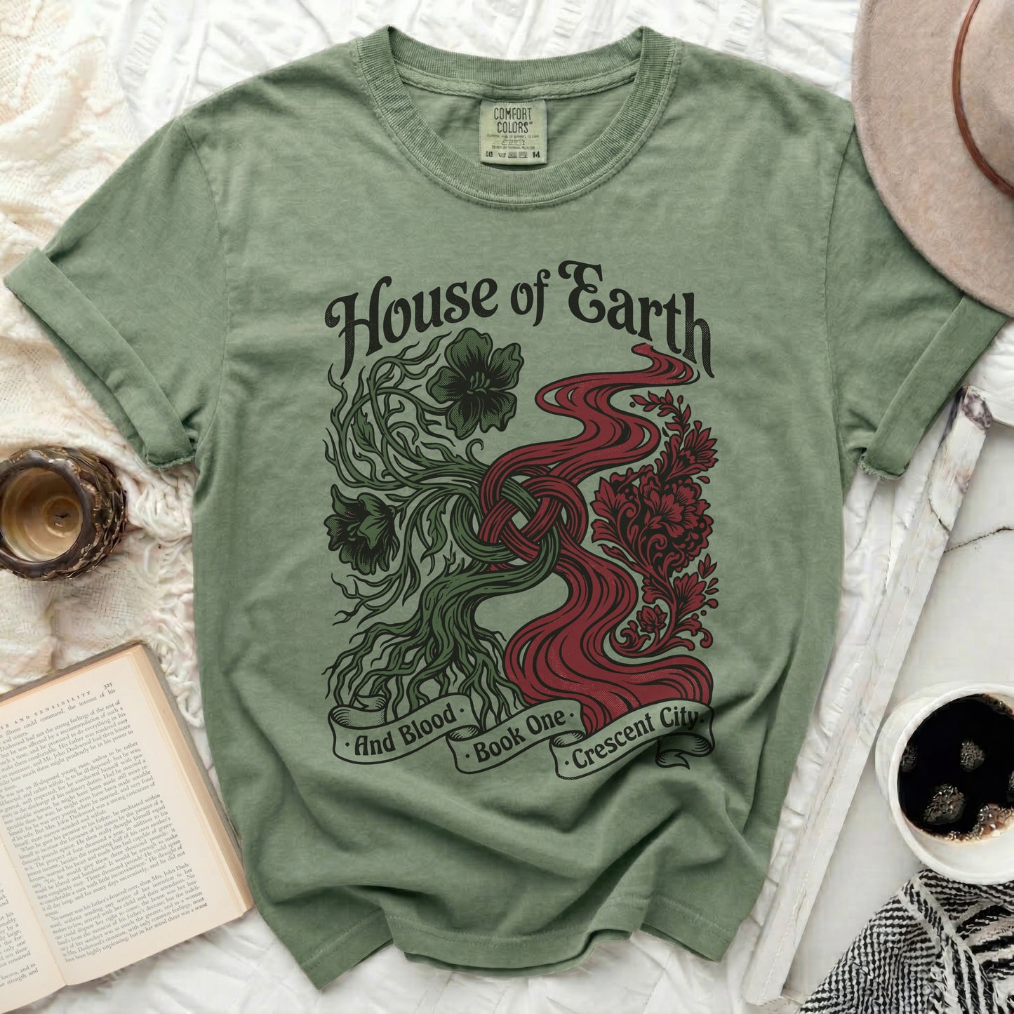 Green t-shirt with "House of Earth and Blood: Book One. Crescent City" design.