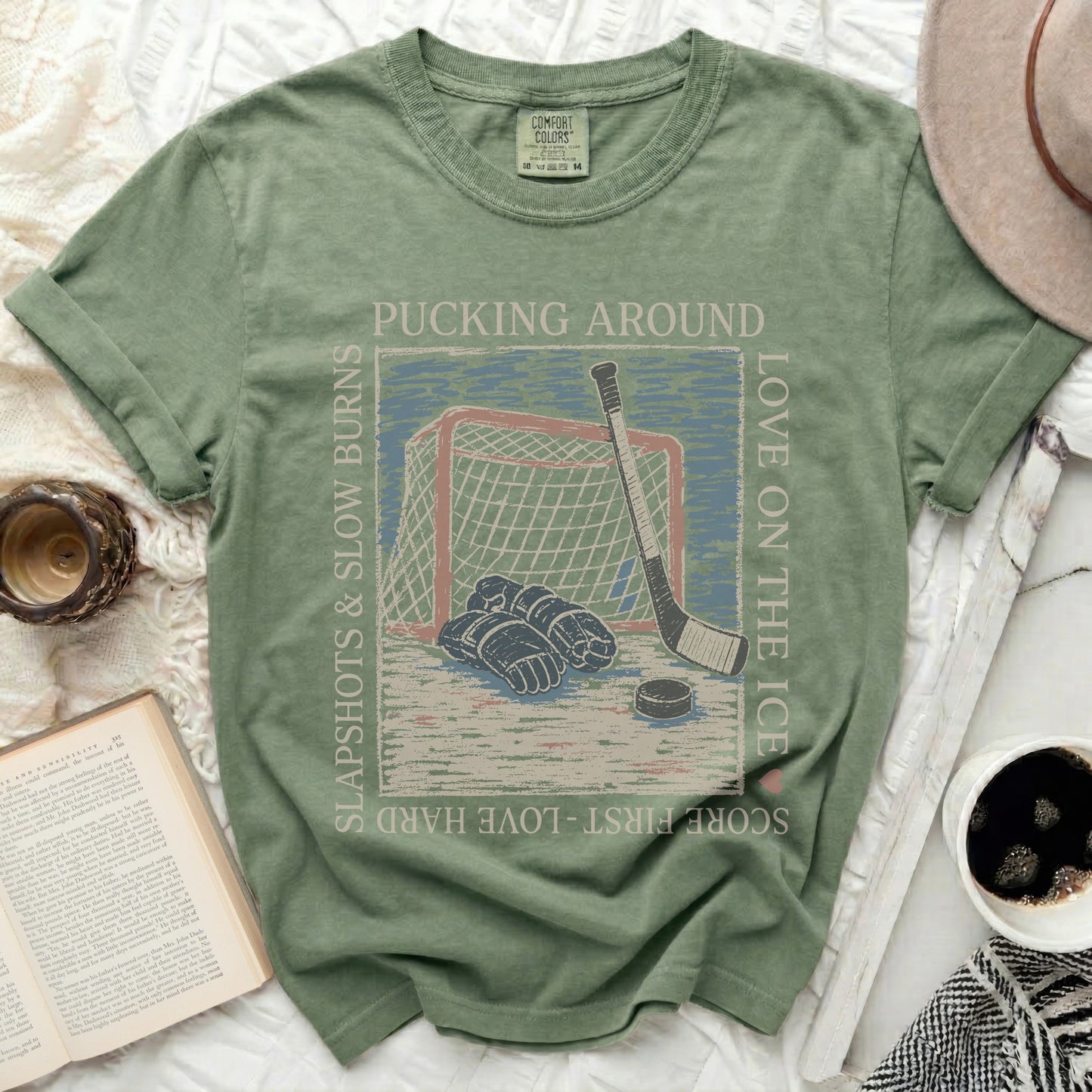 T-shirt with hockey graphic and text: pucking around, love on the ice, slapshot slow burns.