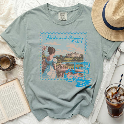 T-shirt with a "Pride and Prejudice" stamp graphic featuring a woman and a manor house.