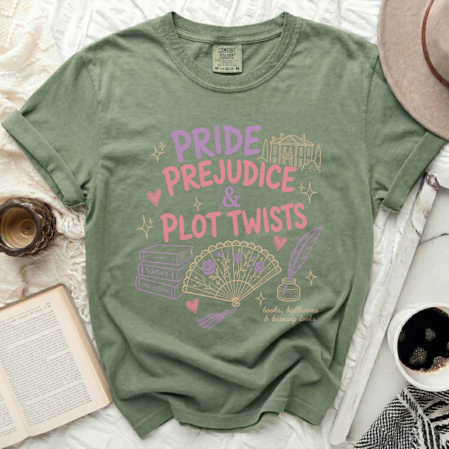 Green t-shirt with "Pride Prejudice & Plot Twists" literary design and book motifs.