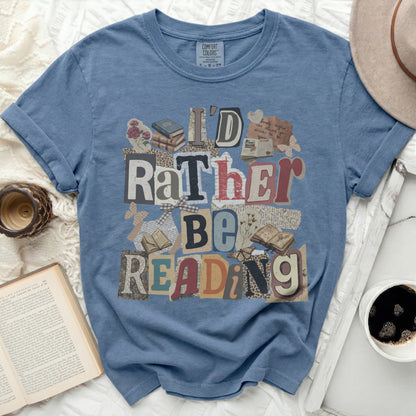 Blue t-shirt with "I'd Rather Be Reading" text collage and books.