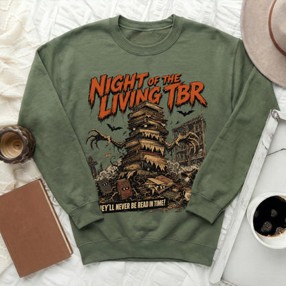 Green sweatshirt featuring a "Night of the Living TBR" graphic with a pile of books.