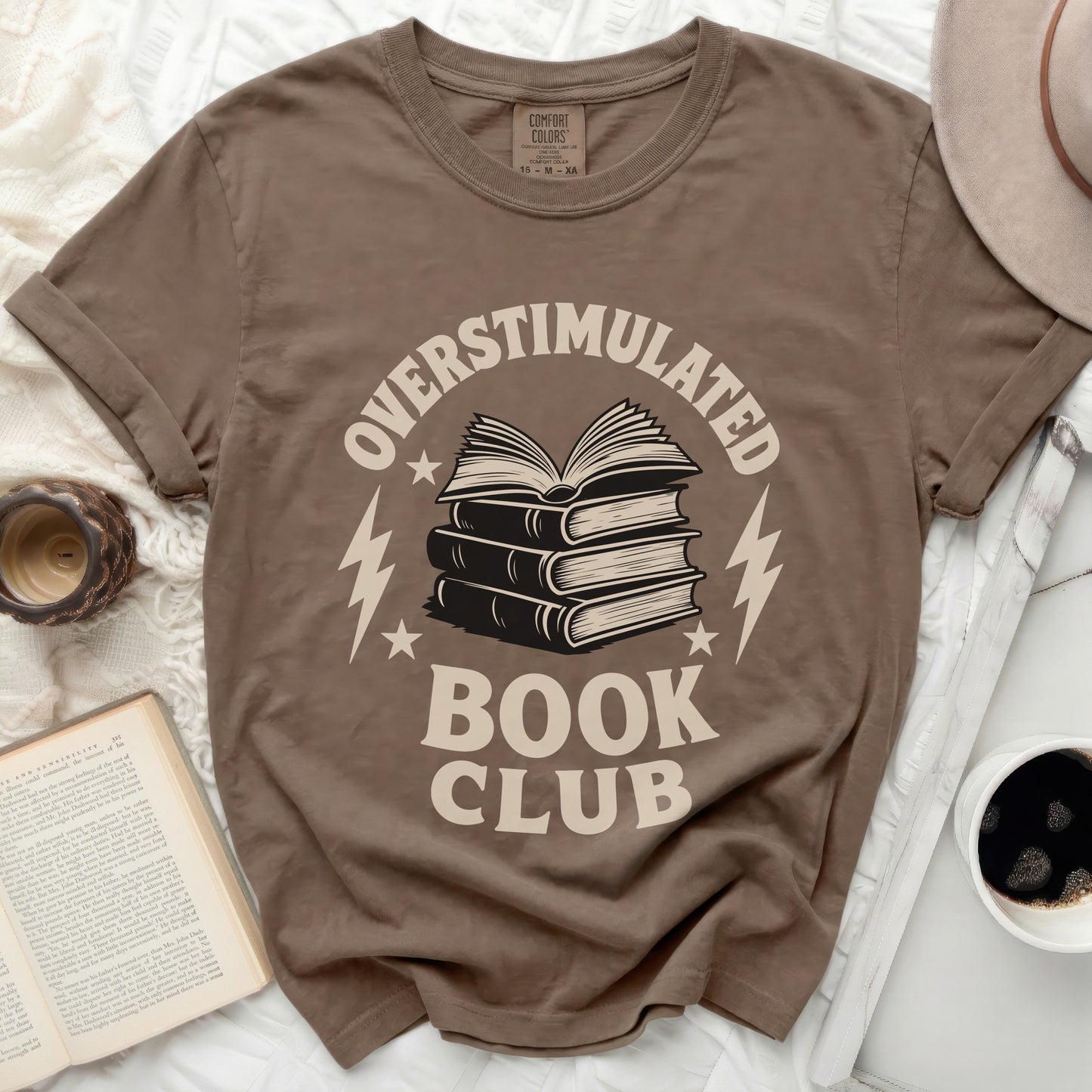 Brown t-shirt with "Overstimulated Book Club" graphic and stacked books.