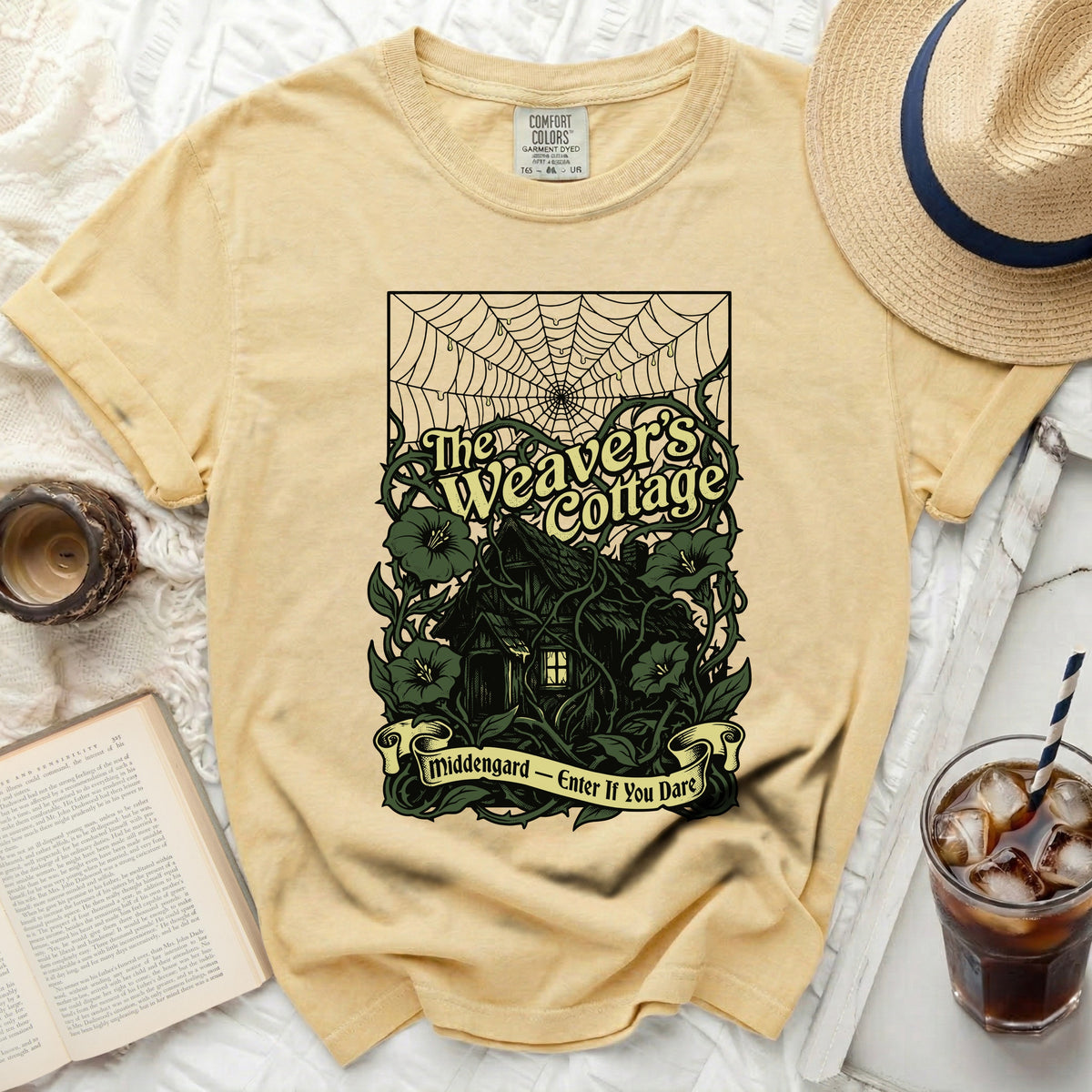 Yellow t-shirt with "The Weaver's Cottage" and "Middengard - Enter If You Dare" graphic.