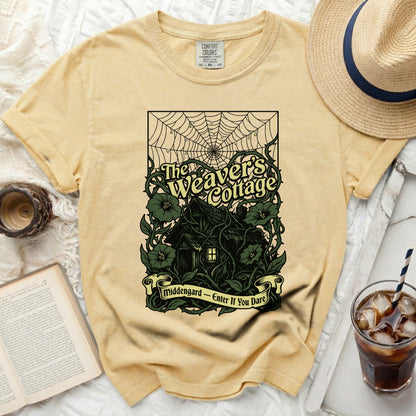 Yellow t-shirt with "The Weaver's Cottage" and "Middengard - Enter If You Dare" graphic.