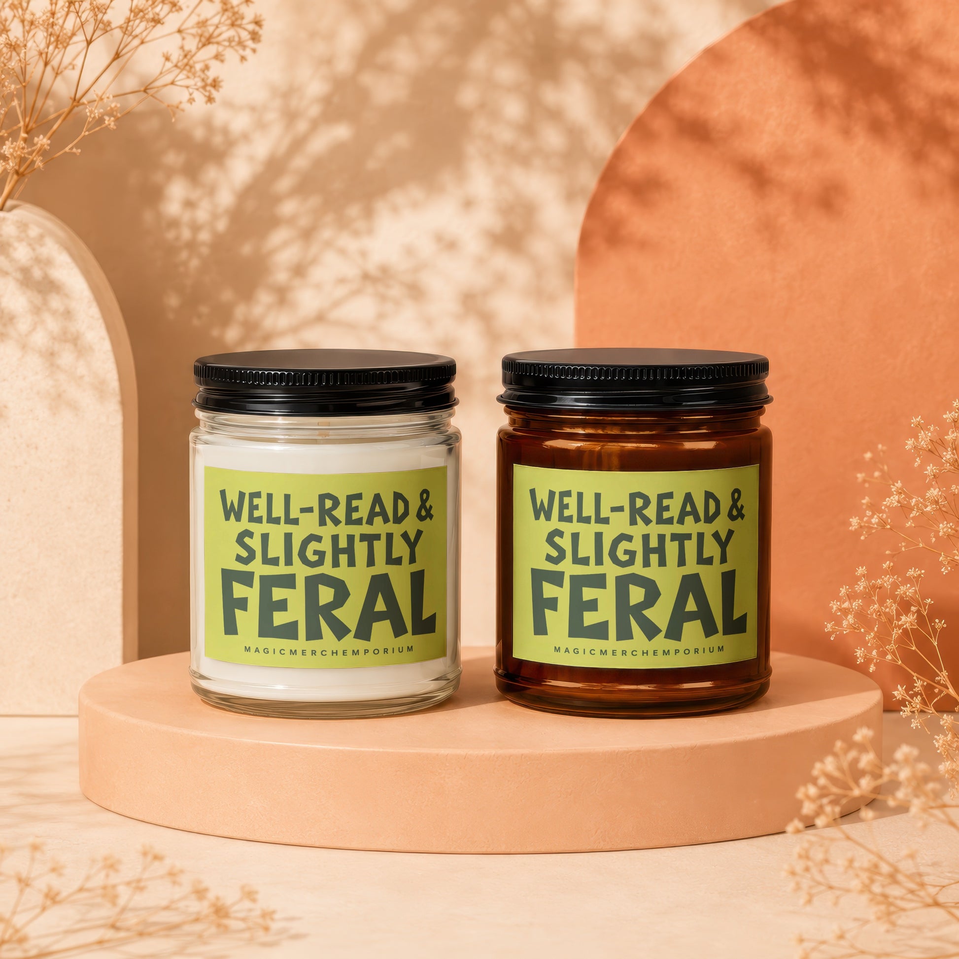 Two candles with labels that read "Well-Read & Slightly Feral".