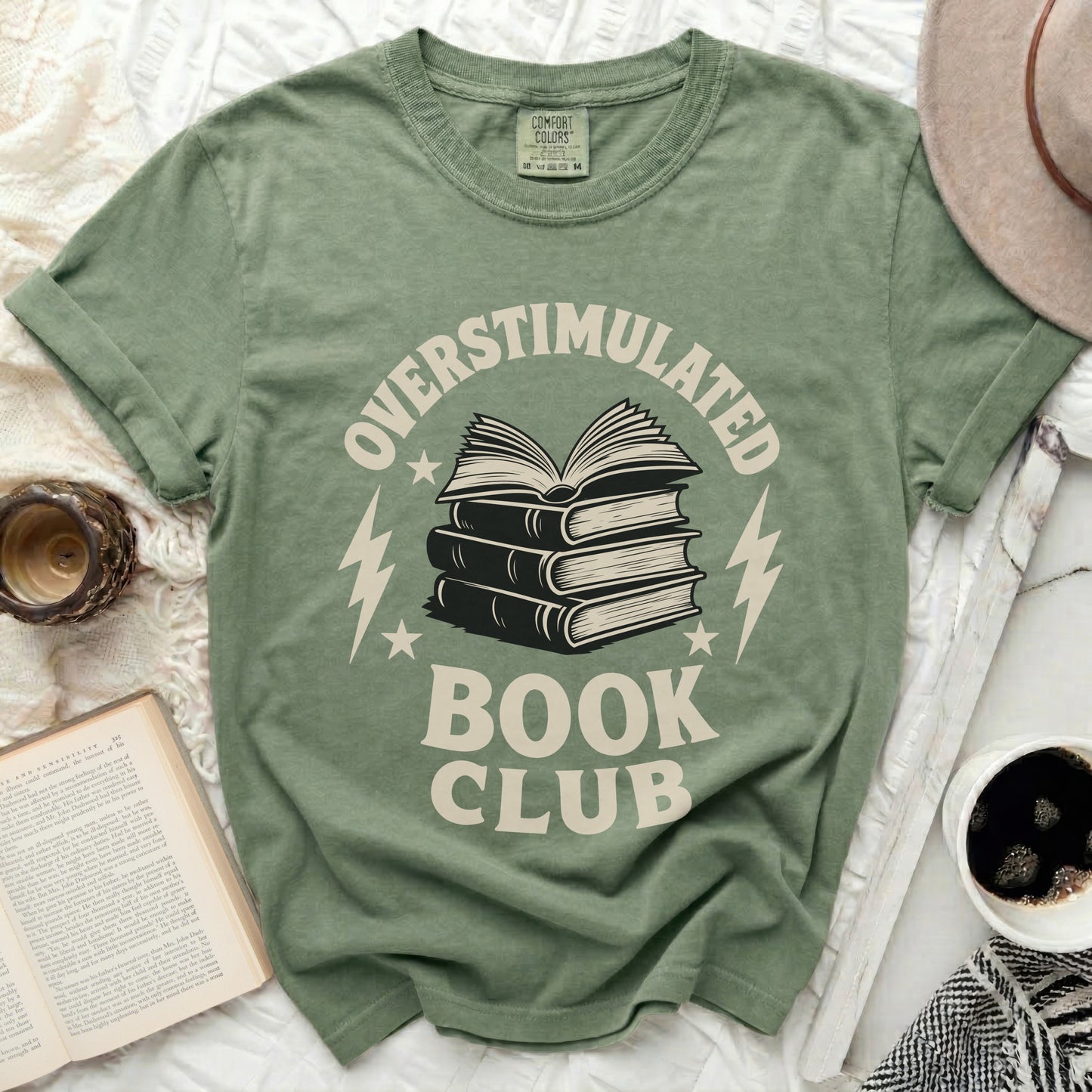 Green t-shirt with "Overstimulated Book Club" text and stack of books graphic.