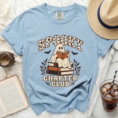 Light blue t-shirt with "Spooky Chapter Club" graphic of a ghost reading.