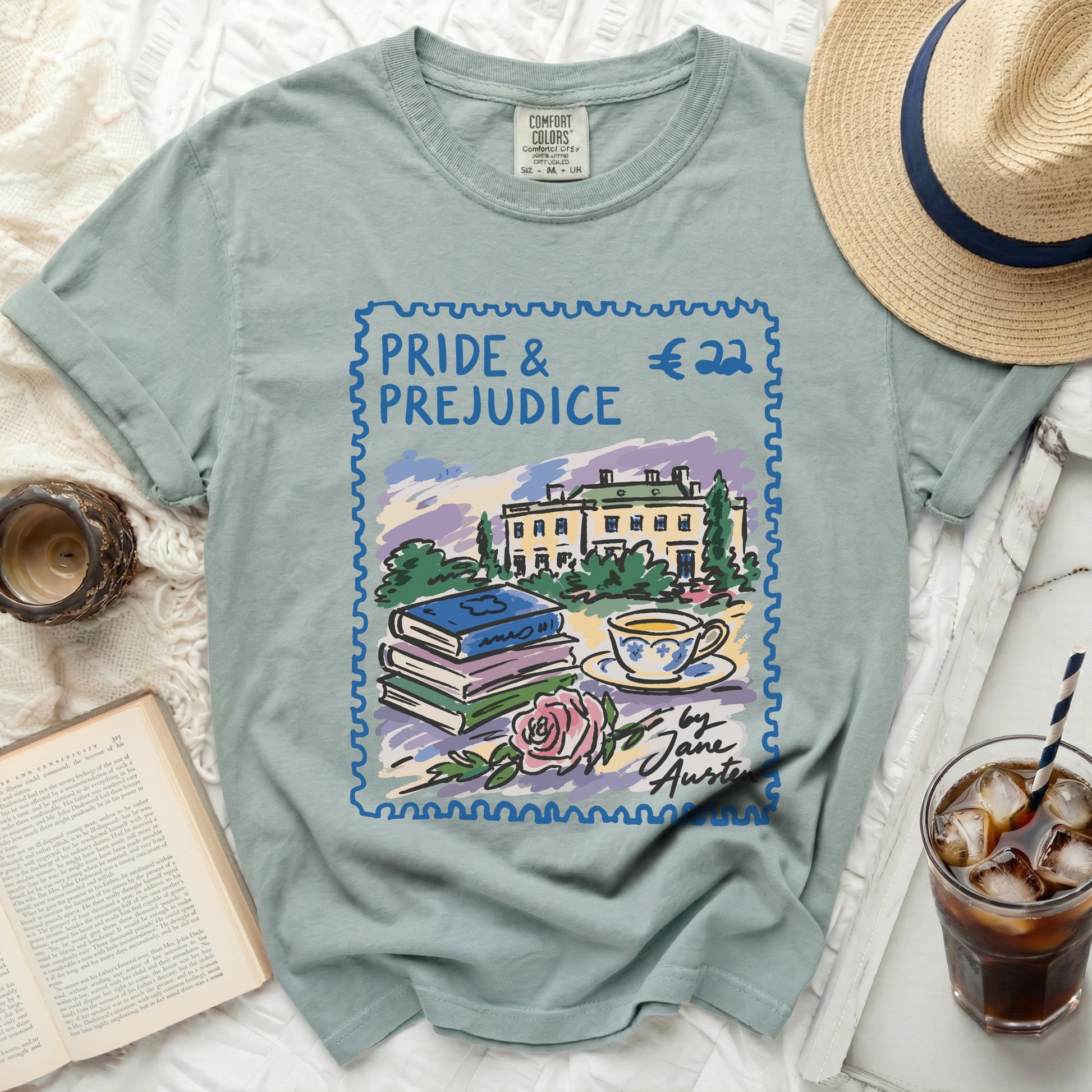 T-shirt with Pride and Prejudice stamp design, books, teacup, and rose.