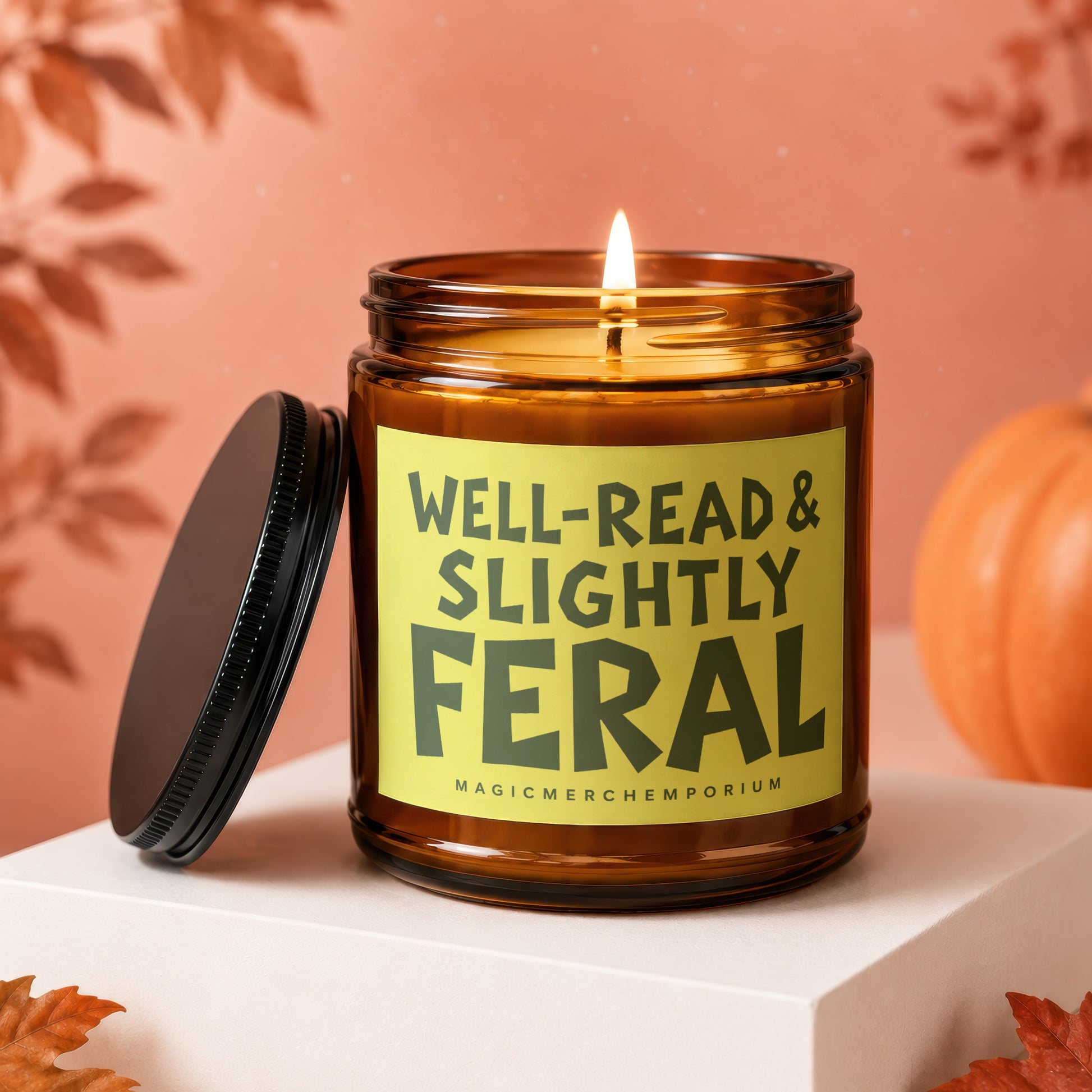 Amber jar candle with lit flame, reads "Well-Read & Slightly Feral."