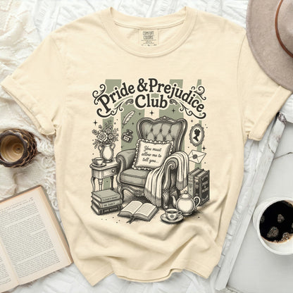 Pride & Prejudice Club graphic on beige t-shirt with armchair and books.