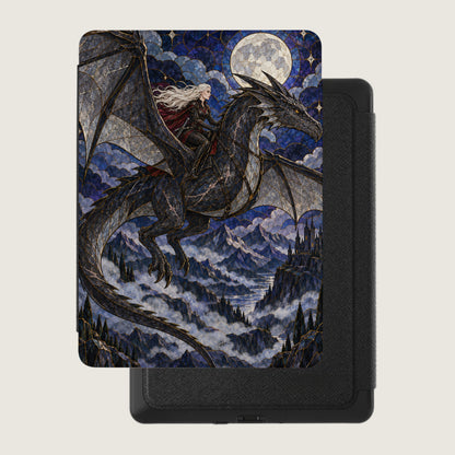 Dragon and rider soar over misty mountains and castle under a full moon.