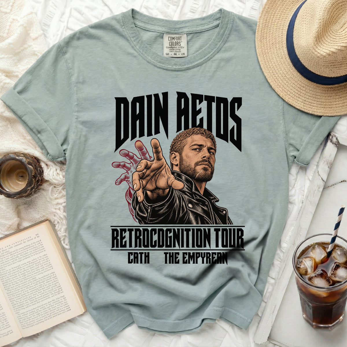 Light blue t-shirt with "Dain Aetos Retrocognition Tour" graphic and man illustration.