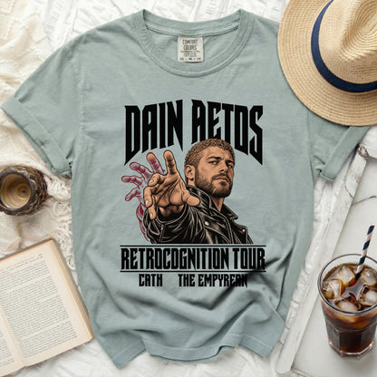 Light blue t-shirt with "Dain Aetos Retrocognition Tour" graphic and man illustration.