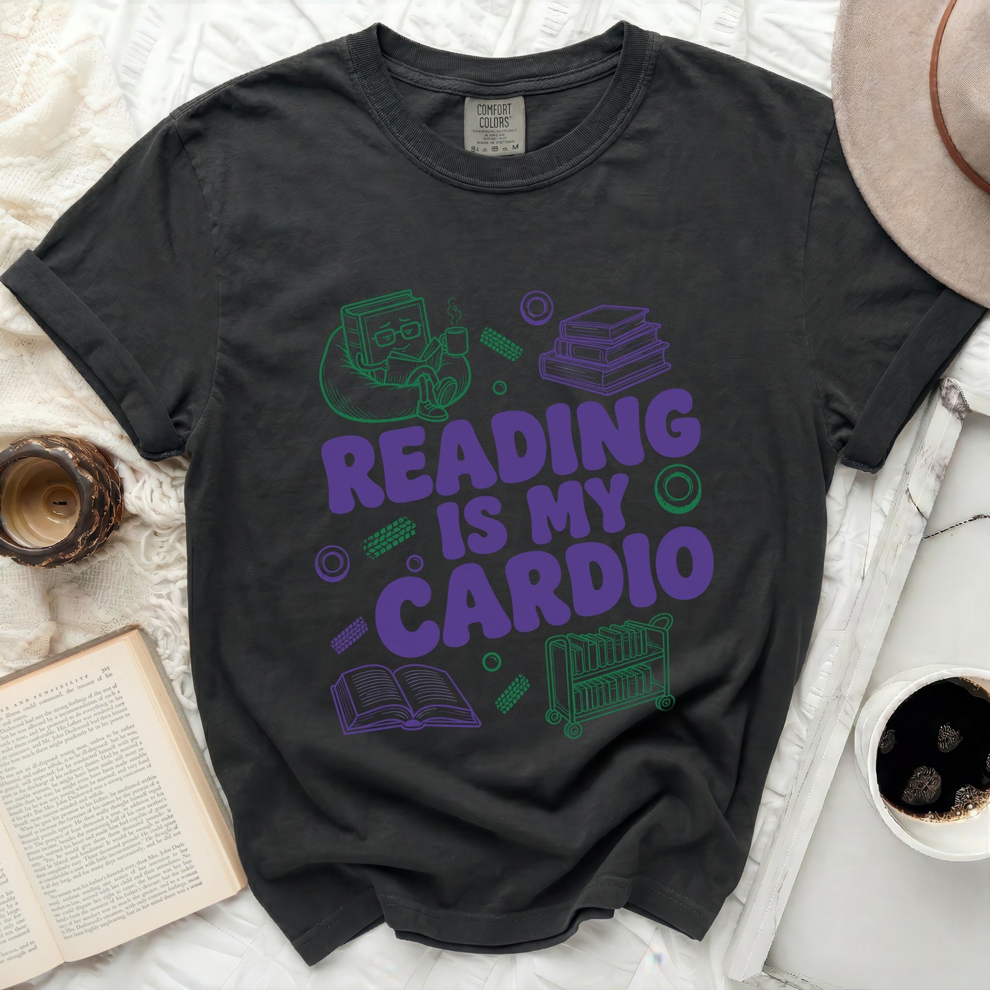 Dark t-shirt with purple and green graphic reading "Reading Is My Cardio."