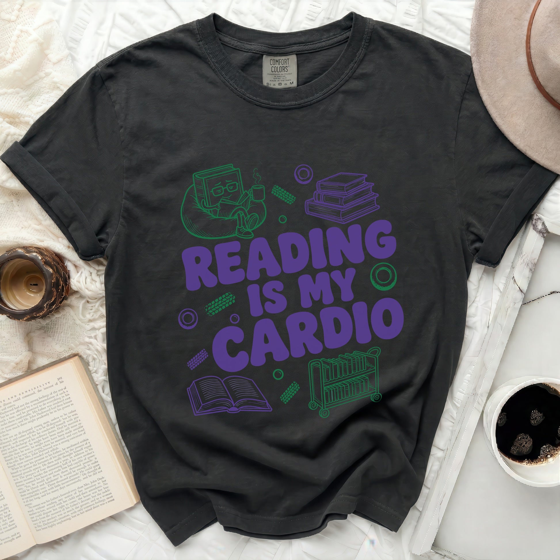 Dark t-shirt with purple and green graphic reading "Reading Is My Cardio."