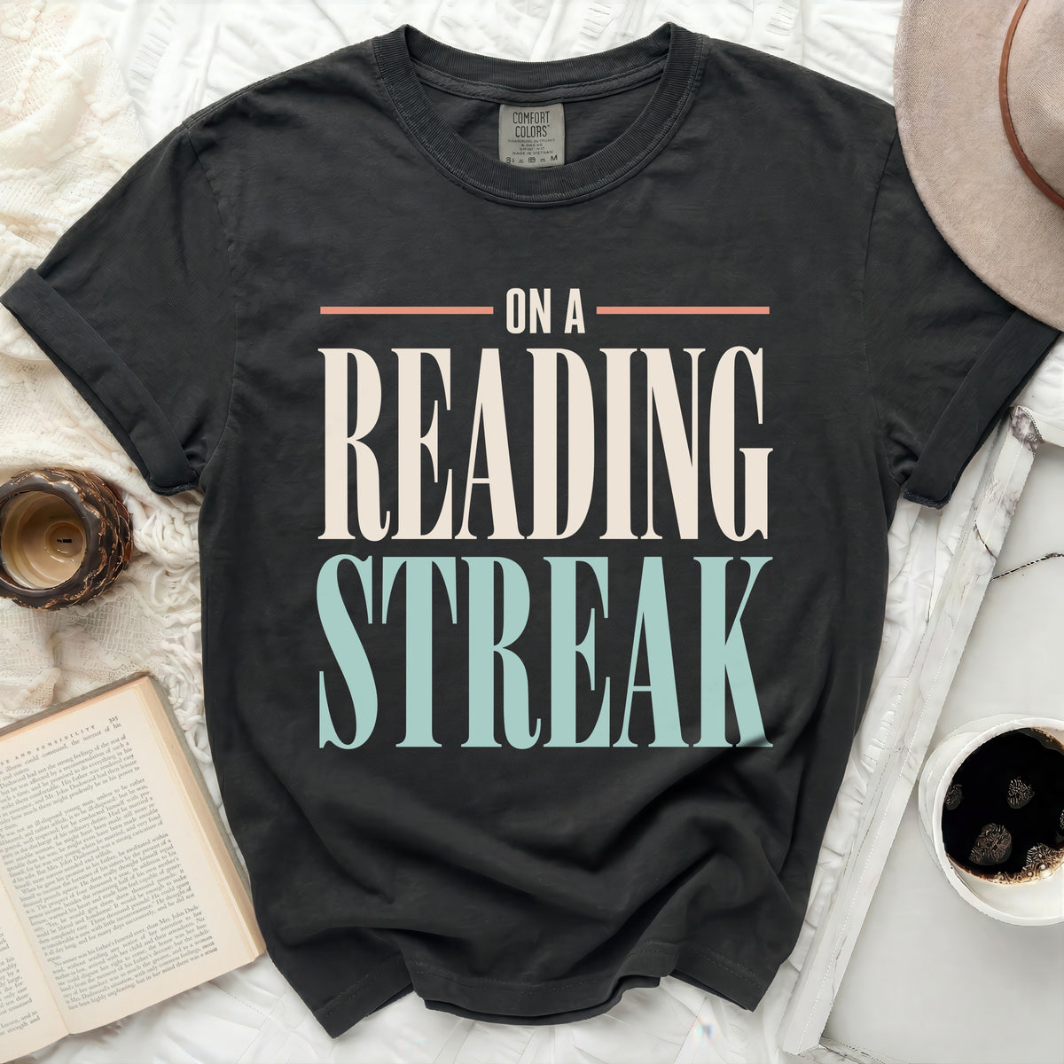 Black t-shirt with "ON A READING STREAK" text in white and light blue.
