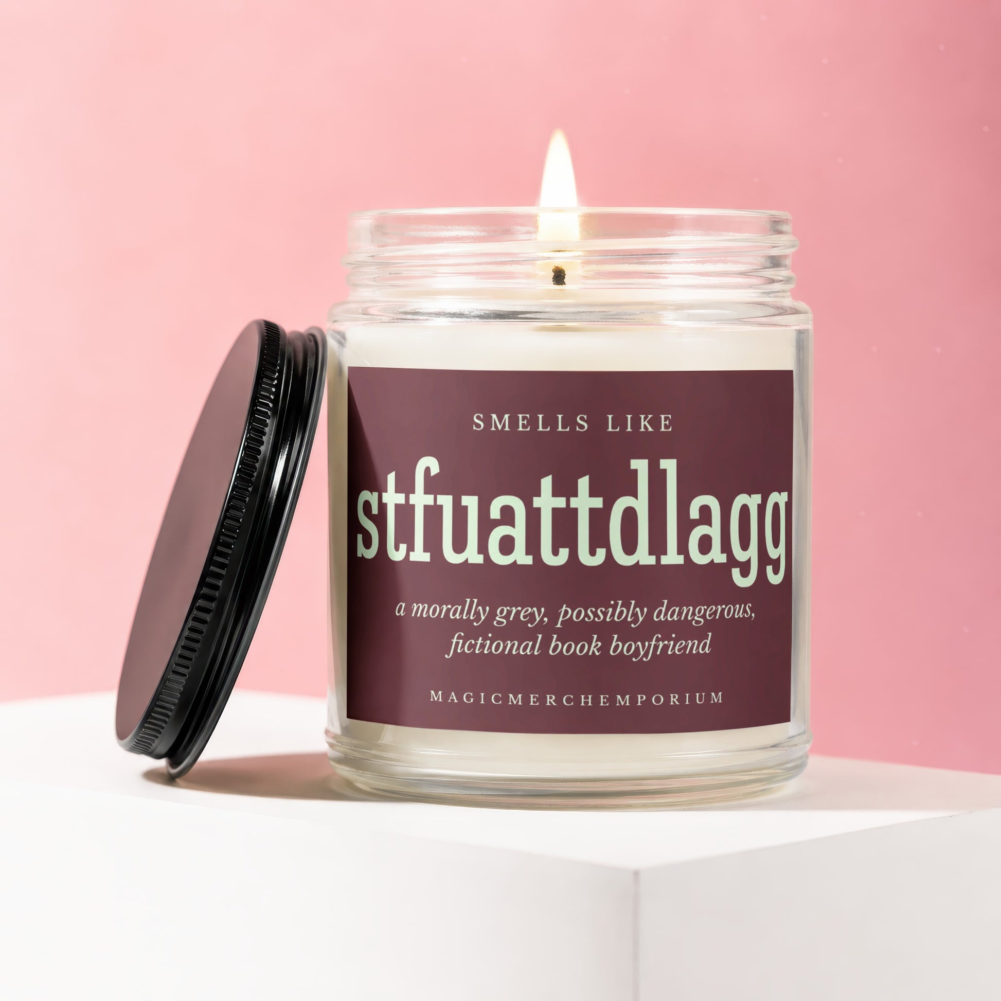 Candle with "STFUATTDLAGG" and "fictional book boyfriend" on label