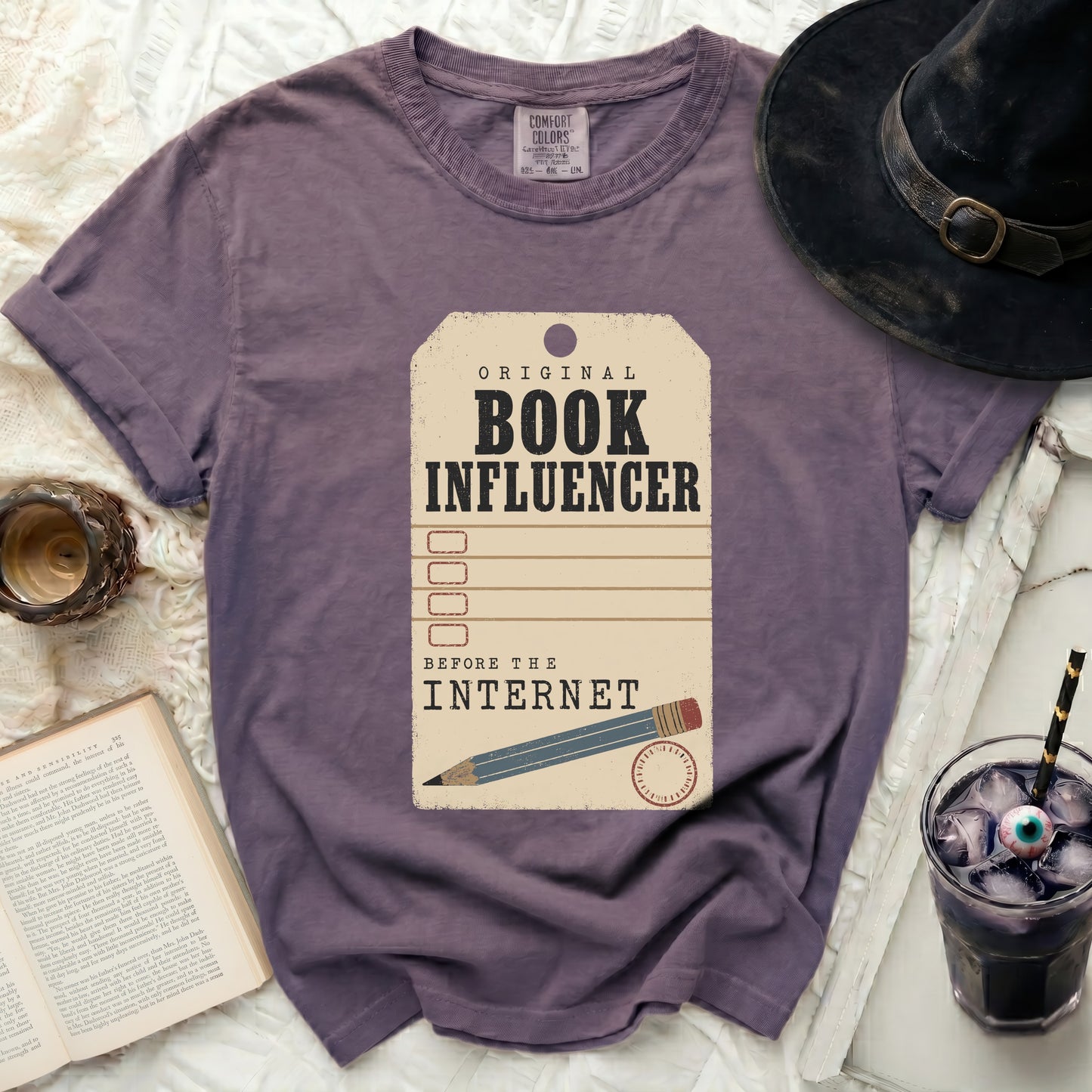 Purple t-shirt with "Original Book Influencer Before The Internet" graphic.