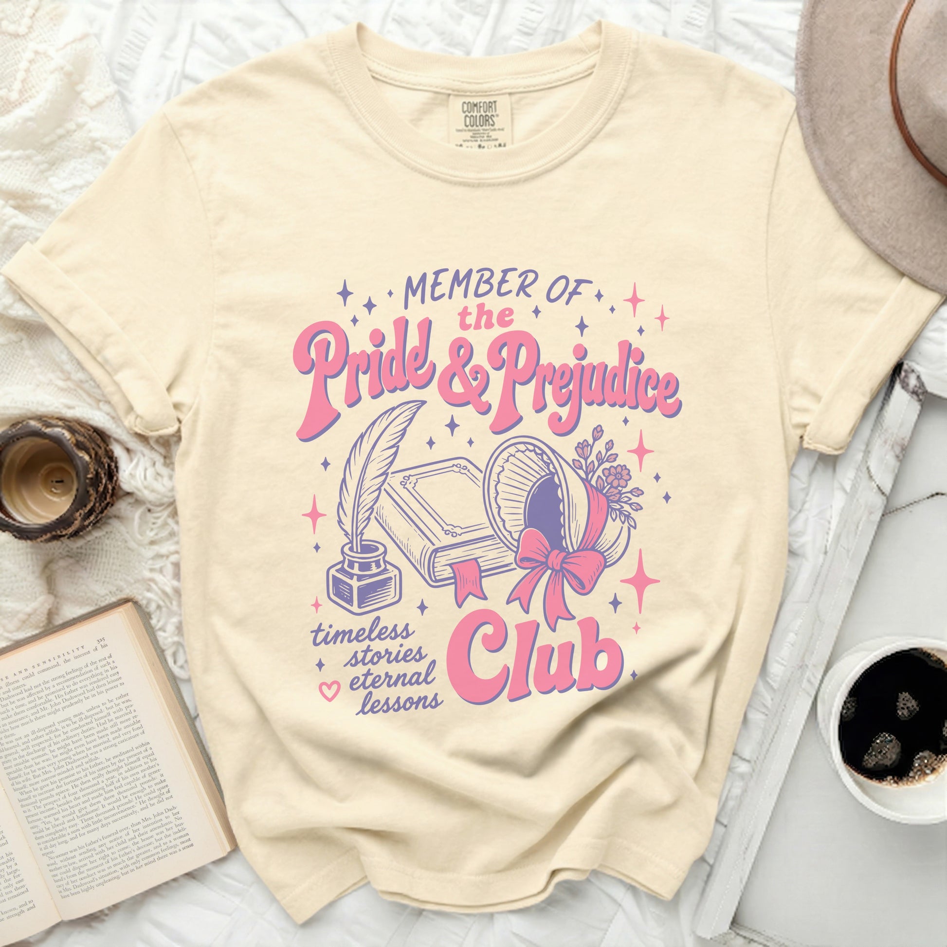 "MEMBER OF the Pride & Prejudice Club" graphic on a cream t-shirt.