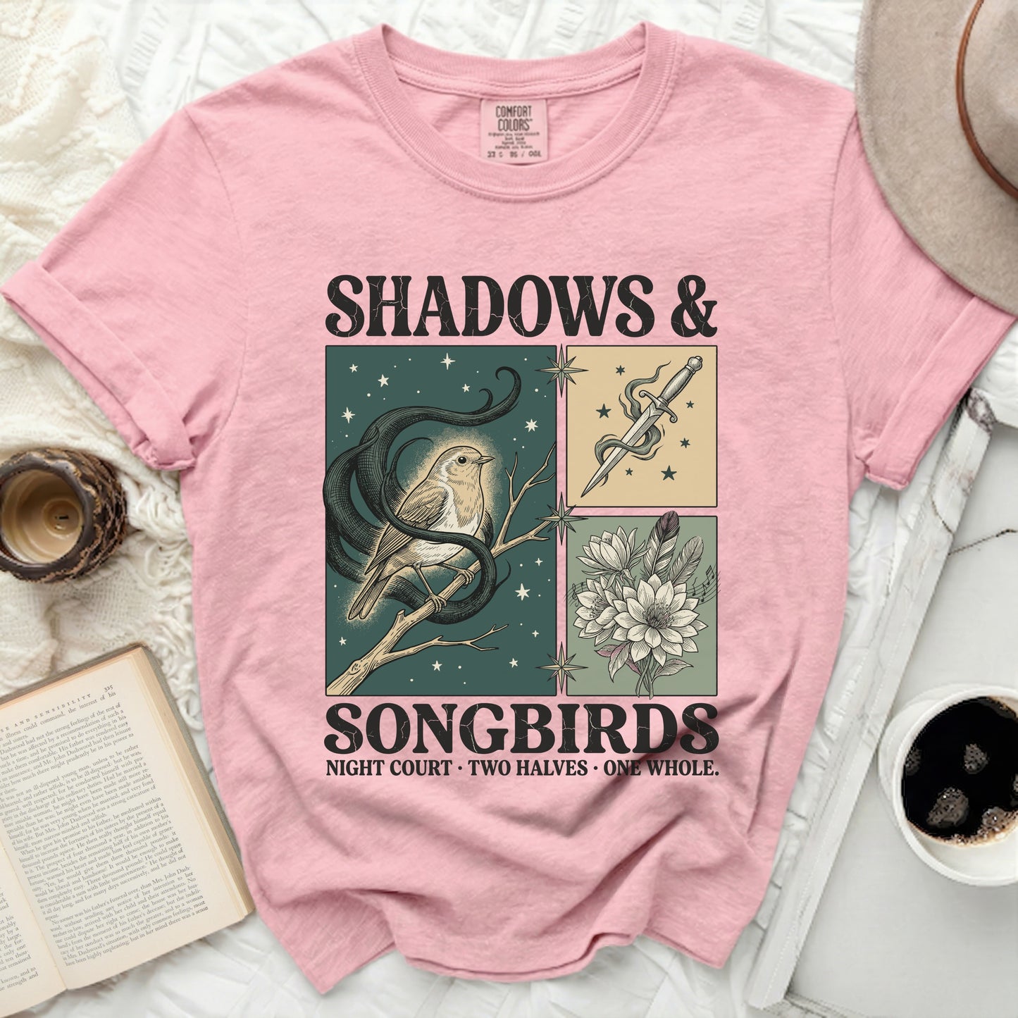 Pink t-shirt with "Shadows & Songbirds" graphic of a bird, snake, sword, and flowers.