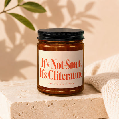Amber jar candle with a white label that reads "It's Not Smut. It's Cliterature."