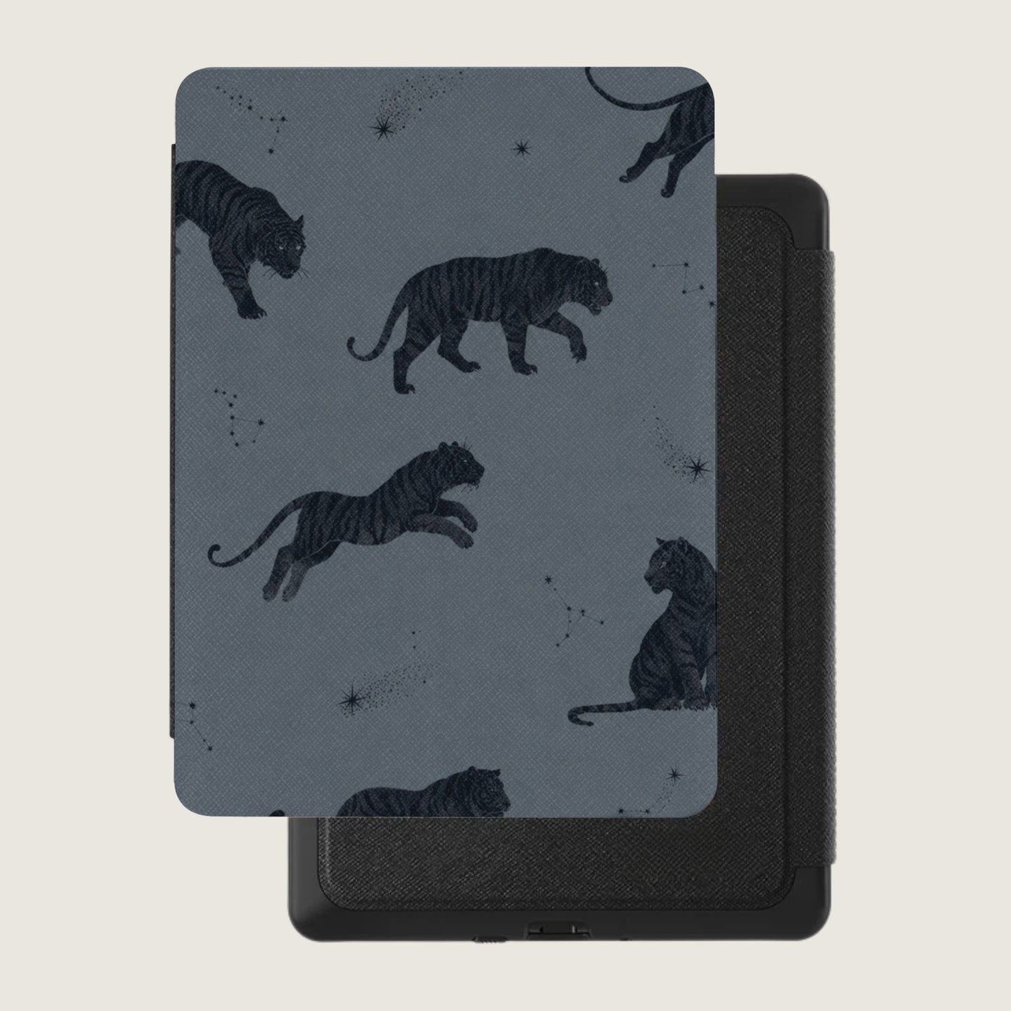 Black tigers and constellations pattern on a gray device cover resting on a black device.